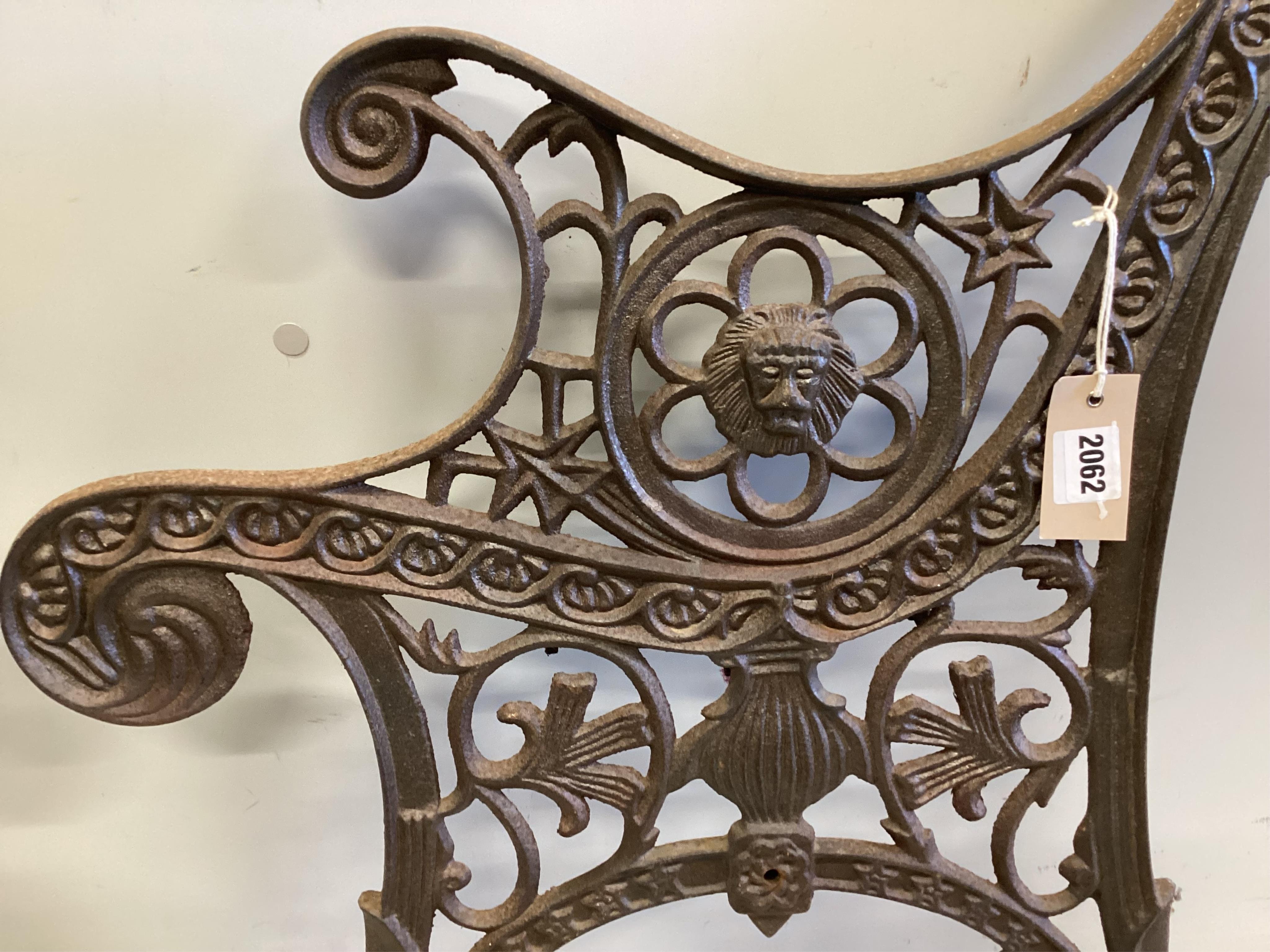 A pair of cast iron bench ends, each width 60cm, height 74cm